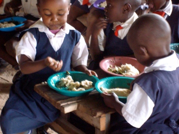 Some of the girls eating ugali and sukuma wiki. (November, 2010)